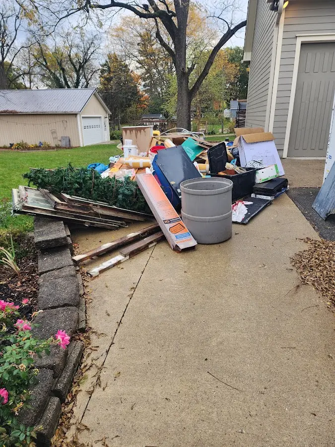 Dumpster being loaded with debris for 12 Yard Dumpster Rental in Redlands